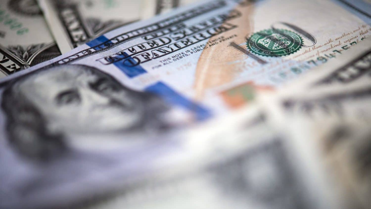 Close-up of a pile of U.S. $100 bills.